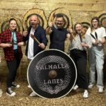 Axe throwing activity at Valhalla Lanes in Colchester, promoted as a fun and safe adrenaline experience for all ages.