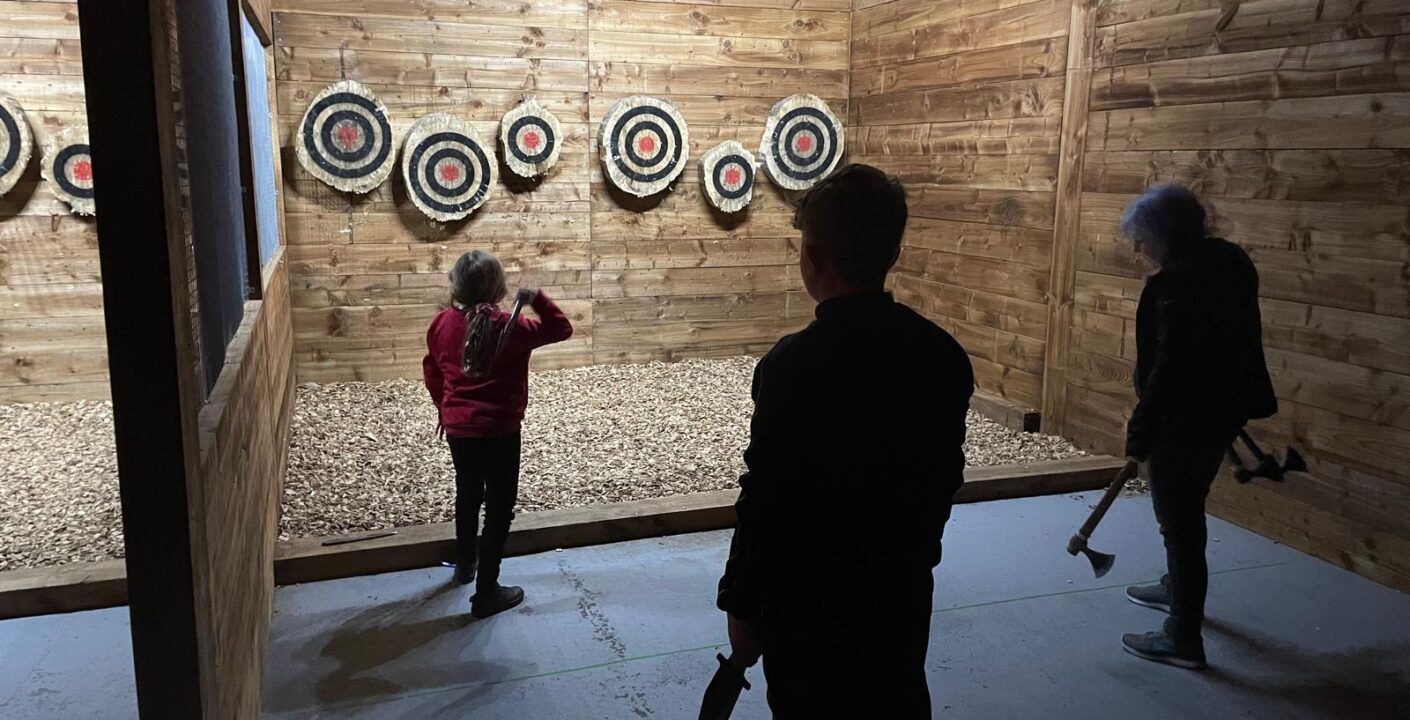 Children enjoying indoor activities Colchester at Valhalla Lanes during a family axe throwing session
