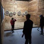 Children enjoying indoor activities Colchester at Valhalla Lanes during a family axe throwing session
