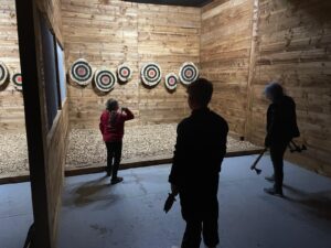 Children enjoying indoor activities Colchester at Valhalla Lanes during a family axe throwing session